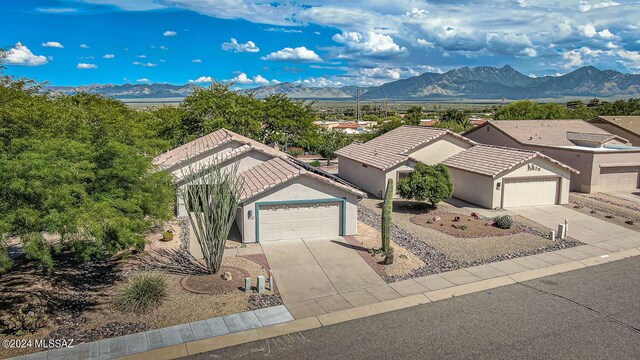 view of front of property with a garage and a mountain view