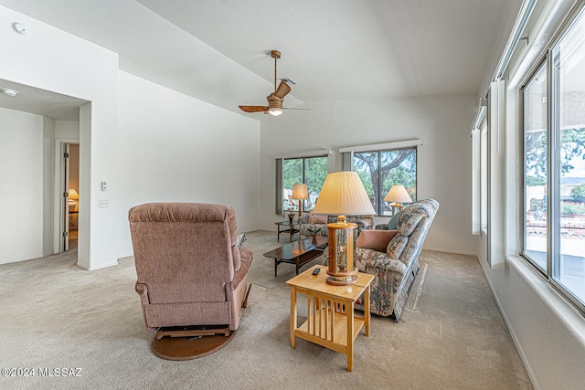 carpeted living room featuring vaulted ceiling and ceiling fan