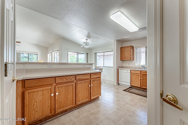 kitchen featuring white dishwasher, vaulted ceiling, sink, light tile patterned flooring, and ceiling fan