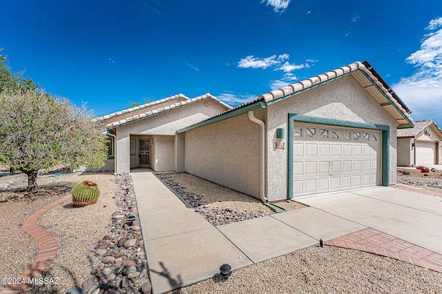 ranch-style house featuring a garage