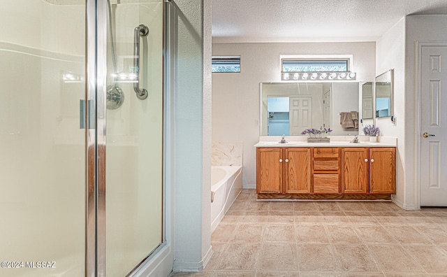 bathroom with vanity, a textured ceiling, plus walk in shower, and tile patterned floors