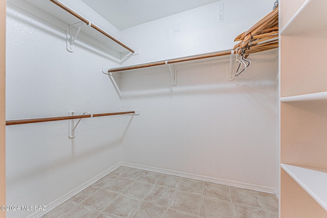 spacious closet featuring light tile patterned floors