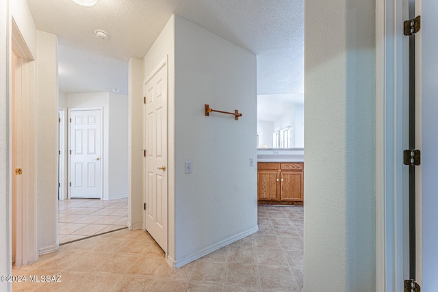 hall with light tile patterned floors