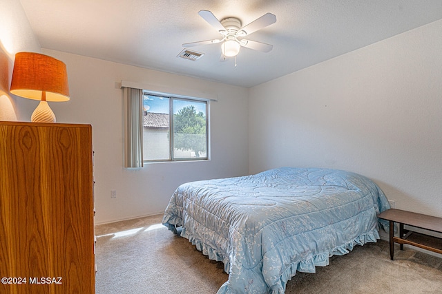 bedroom with ceiling fan and carpet floors