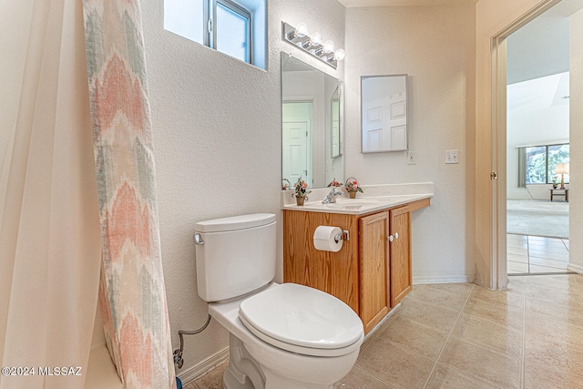 bathroom with tile patterned flooring, toilet, and vanity