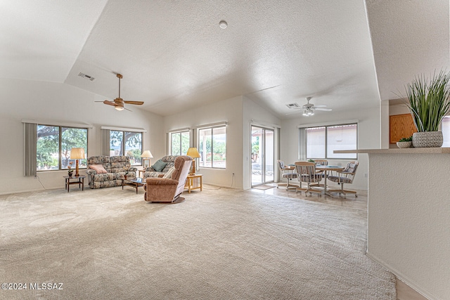 living room with lofted ceiling, light colored carpet, and a wealth of natural light