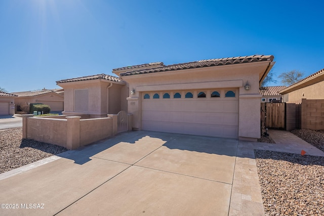 mediterranean / spanish-style home with a garage