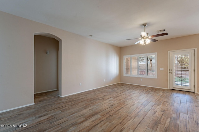 empty room featuring hardwood / wood-style flooring and ceiling fan