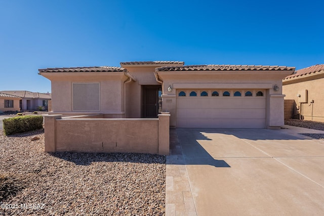 mediterranean / spanish-style home with a garage