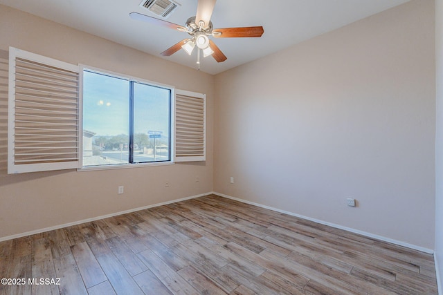 empty room featuring ceiling fan and light hardwood / wood-style floors