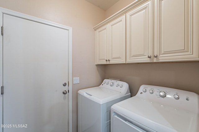 laundry area with cabinets and washing machine and dryer