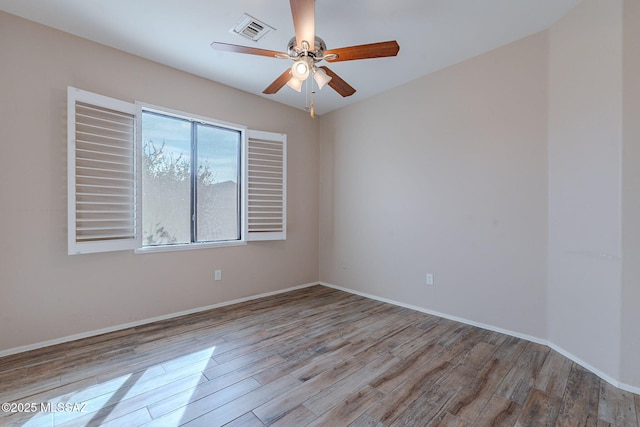 spare room featuring light hardwood / wood-style flooring and ceiling fan