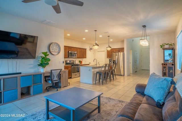 living room featuring light tile patterned flooring, visible vents, recessed lighting, and ceiling fan