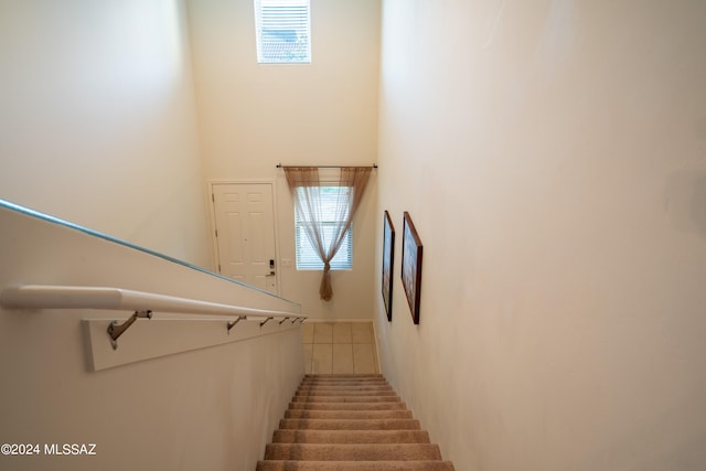 staircase featuring tile patterned flooring