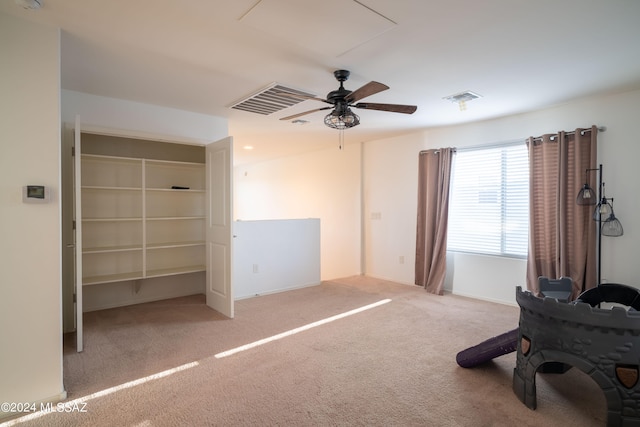 unfurnished bedroom featuring a closet, ceiling fan, and light colored carpet