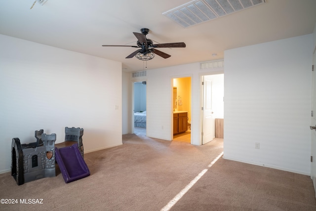 interior space with ceiling fan and light colored carpet