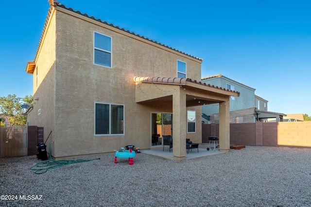 back of property featuring a patio area