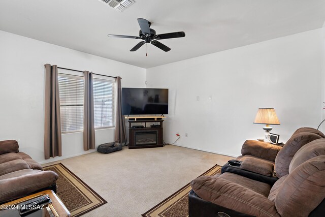 carpeted living room with ceiling fan