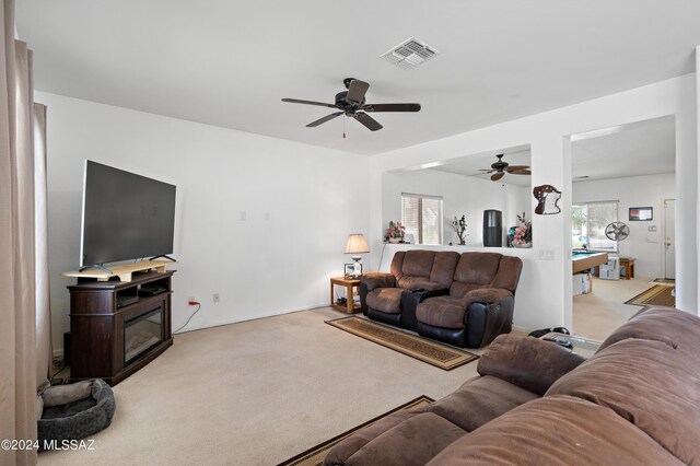 living room featuring ceiling fan and light carpet