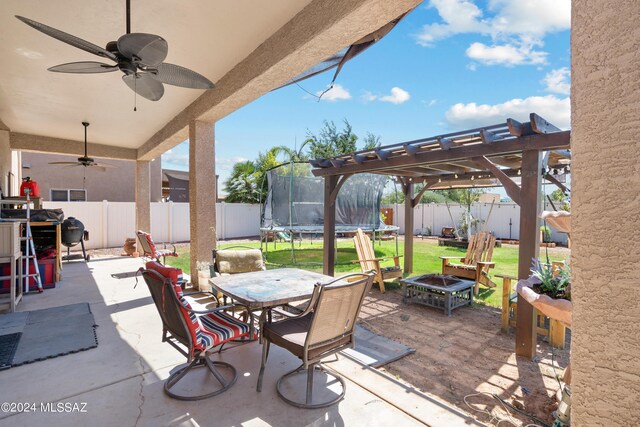 view of patio / terrace with a trampoline, ceiling fan, and a pergola