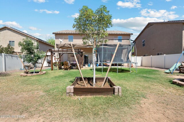 view of yard featuring a playground and a trampoline