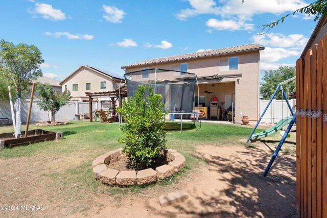 view of yard with a pergola, a trampoline, and a playground