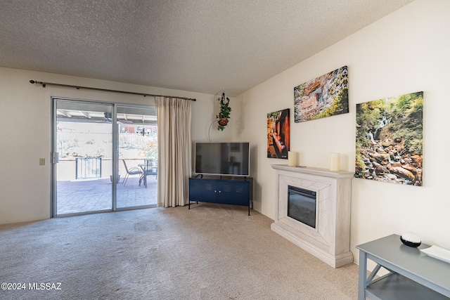 living room featuring light carpet and a textured ceiling