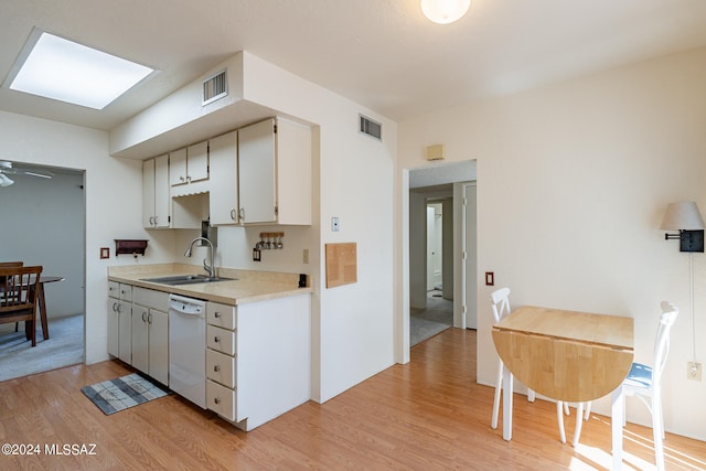 kitchen with white dishwasher, light hardwood / wood-style floors, sink, white cabinetry, and ceiling fan