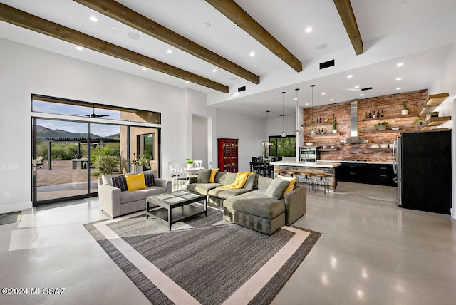 living room featuring brick wall and beam ceiling