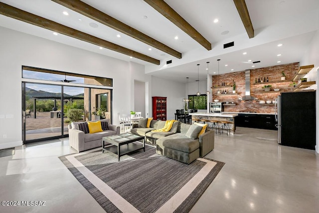 living room featuring beamed ceiling, recessed lighting, and concrete floors