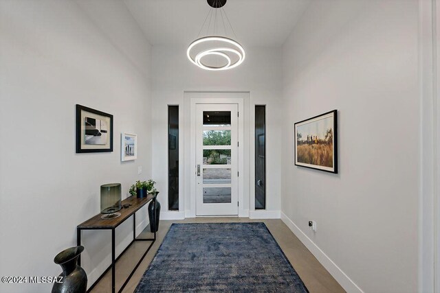 doorway to outside featuring a chandelier