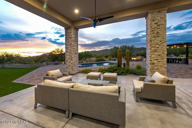 patio terrace at dusk featuring an outdoor living space