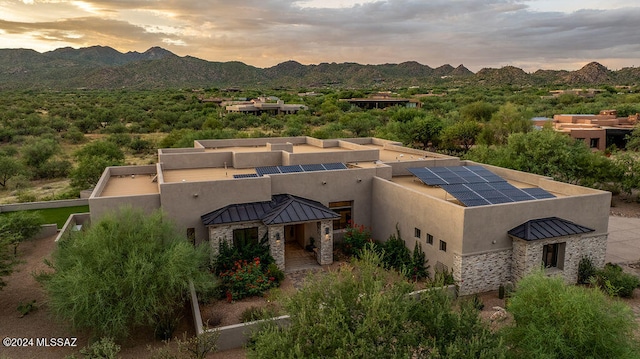 aerial view at dusk featuring a mountain view