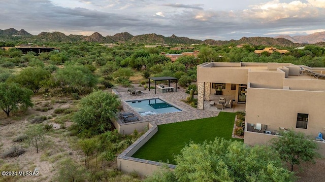 pool featuring a gazebo, a yard, a patio area, and a mountain view