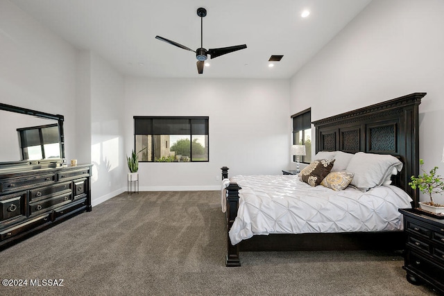 bedroom with high vaulted ceiling, dark colored carpet, and ceiling fan