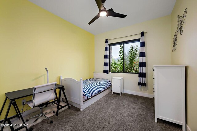 bedroom featuring dark carpet and ceiling fan