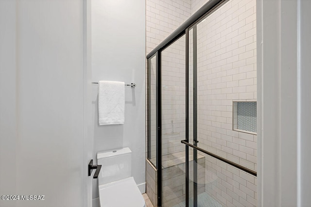 bathroom featuring toilet and walk in shower