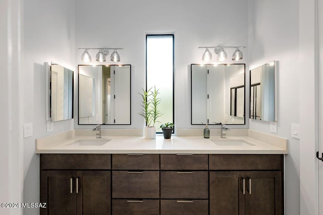 full bathroom with double vanity and a sink