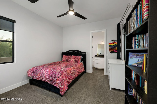 bedroom featuring dark carpet, ensuite bath, and ceiling fan