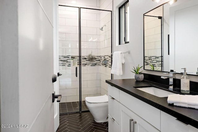 full bathroom with vanity, toilet, and a stall shower