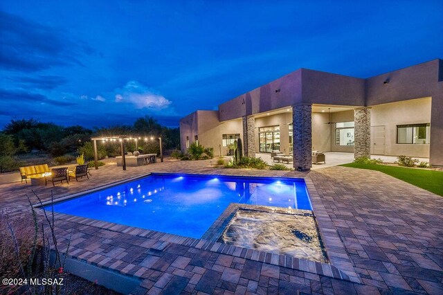 view of pool featuring an outdoor living space, a patio, and a pool with connected hot tub