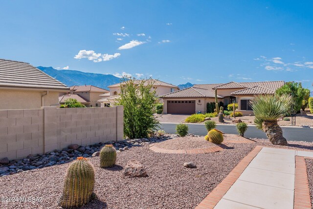 view of yard featuring a garage and a mountain view