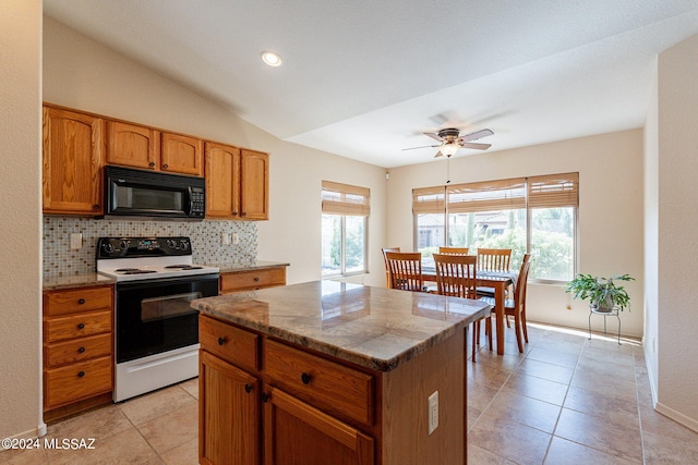 kitchen featuring light stone counters, ceiling fan, white electric range oven, decorative backsplash, and lofted ceiling