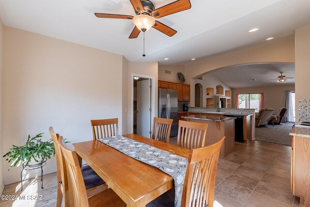 dining space with lofted ceiling, ceiling fan, and sink