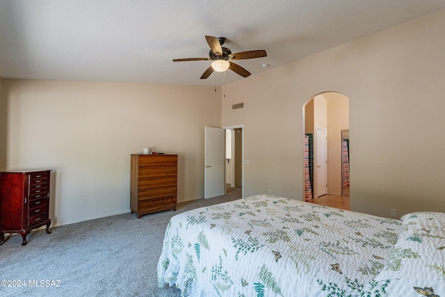 bedroom featuring vaulted ceiling, carpet flooring, a ceiling fan, visible vents, and arched walkways