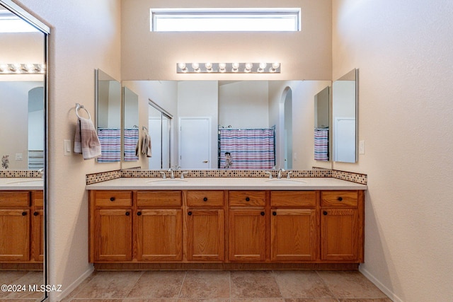 bathroom with curtained shower and vanity