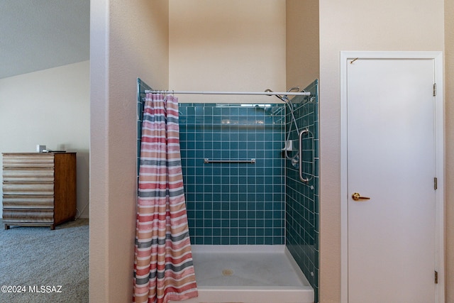 bathroom featuring lofted ceiling and walk in shower