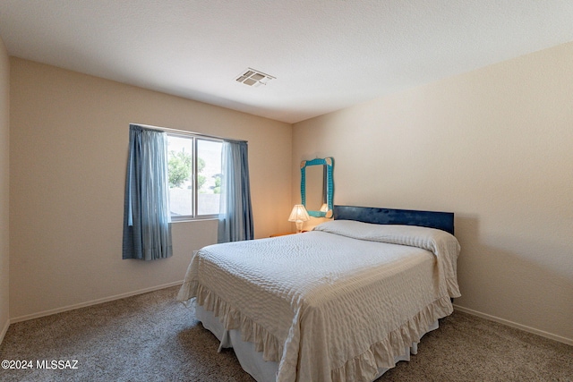 carpeted bedroom featuring baseboards and visible vents