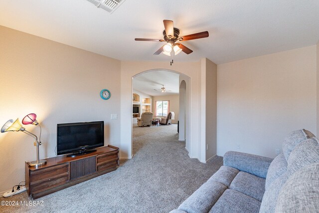 living room featuring ceiling fan and carpet floors