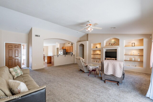 living room featuring light carpet, built in features, ceiling fan, and lofted ceiling